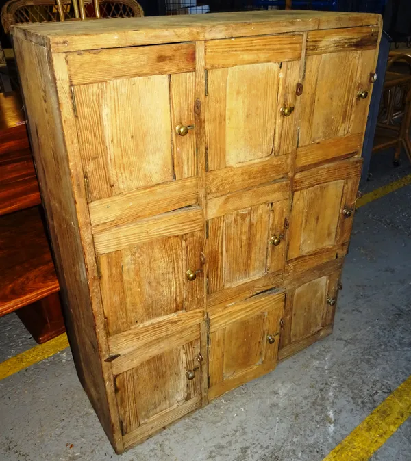 An early 20th century pine storage locker with nine cupboard, 86cm wide x 100cm high.  EXTRA