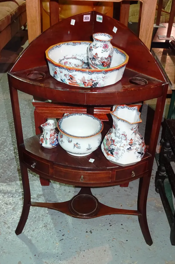 A Regency mahogany bowfront corner wash stand, with an accompanying Masons matched six piece wash set, 52cm wide x 95cm high.  I5