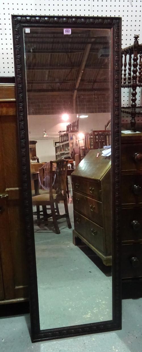 An early 20th century oak framed rectangular mirror with egg and dart carved frame, 49cm wide x 146cm high.  MIRR