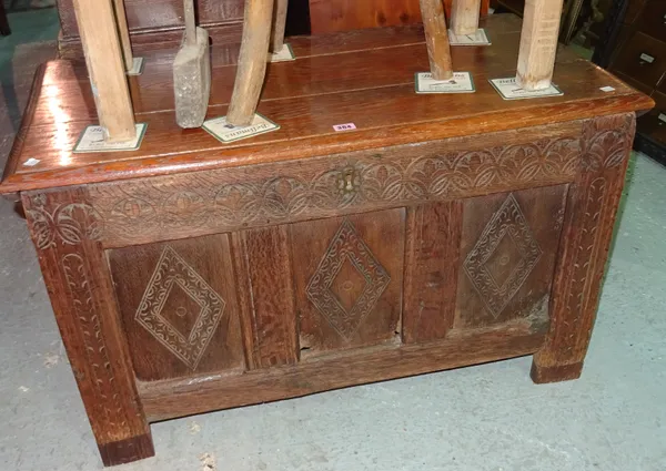 An 18th century and later oak coffer, with floral carved three panel front, 96cm wide.   G9