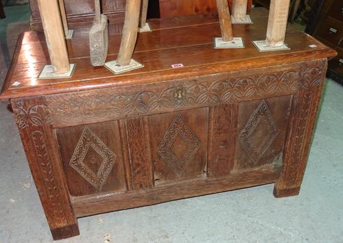 An 18th century and later oak coffer, with floral carved three panel front, 96cm wide.   G9