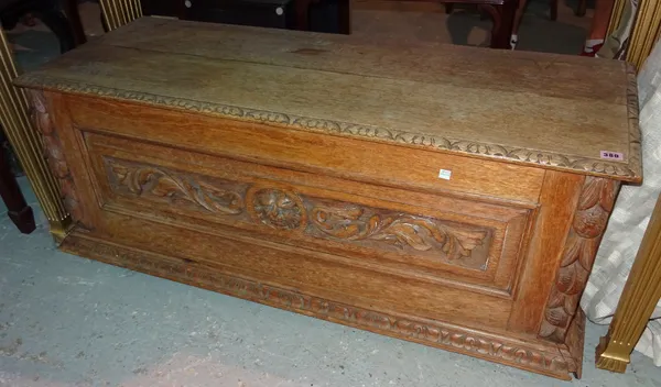 A late 19th century carved faded oak cassone style trunk, 124cm wide x 46cm high.   G6