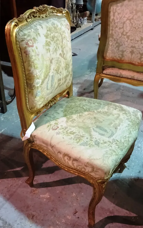 A set of three Louis XVI style gilt framed side chairs with serpentine seat and scroll supports, 52cm wide x 93cm high (3).  E4