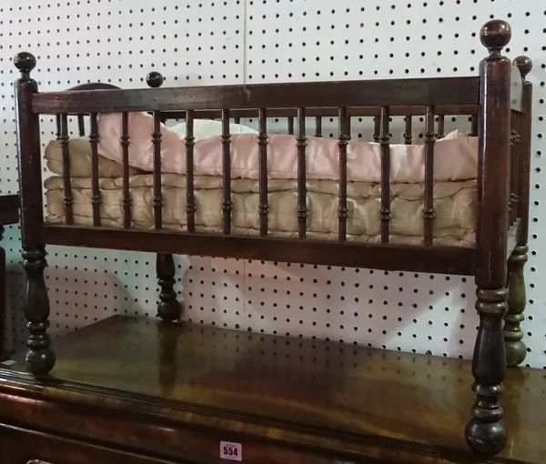 An early 20th century mahogany farmed child's crib with turned spindle decoration 65cm wide x 57cm high. F10