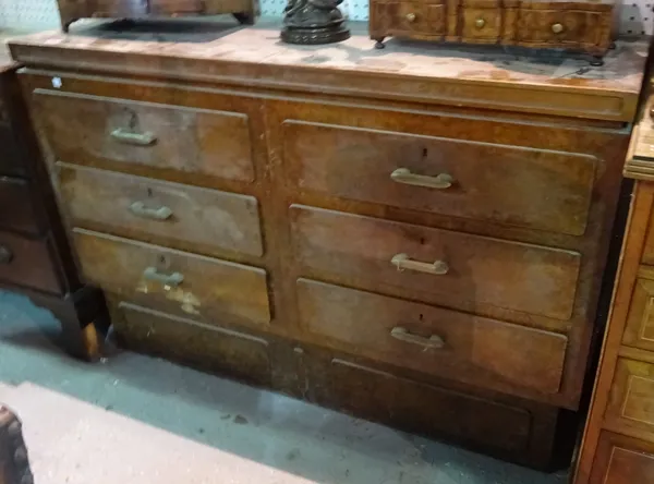 A mid-20th century figured walnut chest of six short drawers on plinth base, 132cm wide x 89cm high.  A5