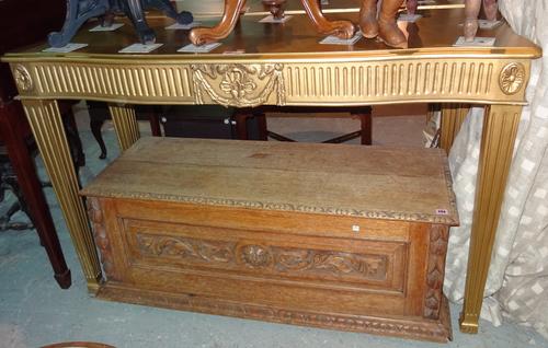 A pair of 18th century style gold painted serpentine top console tables, on tapering square supports, 146cm wide x 93cm high x 55cm deep (2).  G6