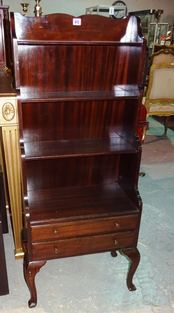 A 20th century mahogany waterfall bookcase with two drawers to the base, on cabriole supports, 50cm wide x 124cm high.   F5