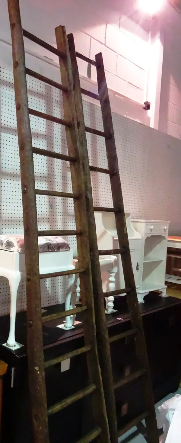 A pair of early 20th century elm twelve rung ladders, 280cm high (2).  H10