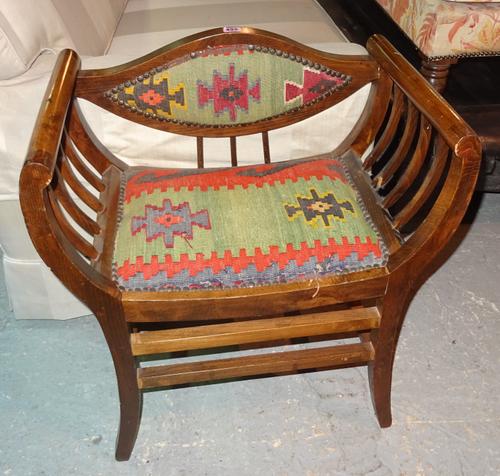 A pair of early 20th century mahogany armchairs with kelim studded upholstery (2).  G7