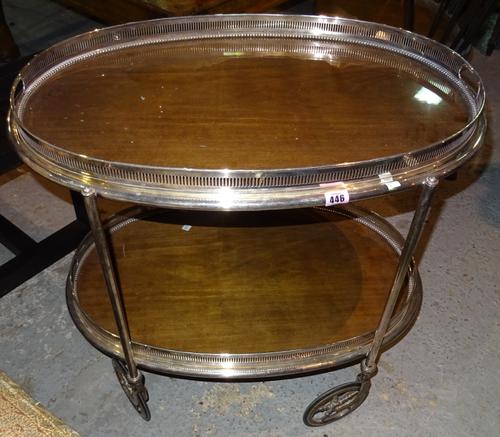 A n early 20th century silver plated serving serving trolley, fitted with two oval gallery trays, 75cm wide.   H4