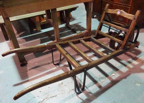 An early 20th century oak and iron wheelbarrow.   EXTRA