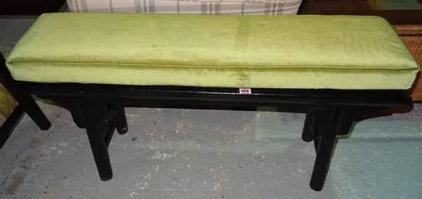 An early 20th century stained black hardwood Chinese altar table with later added green cushion, 110cm wide x 55cm high.  J8