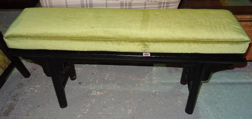 An early 20th century stained black hardwood Chinese altar table with later added green cushion, 110cm wide x 55cm high.  J8