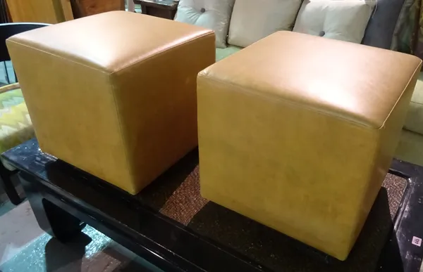 Ben Whistler, a pair of 20th century faux tan leather square footstools on hardwood plinth bases, 45cm wide x 50cm high.   J9