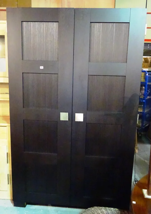 A 20th century hardwood double wardrobe on block supports, 130cm wide x 205cm high.  M6