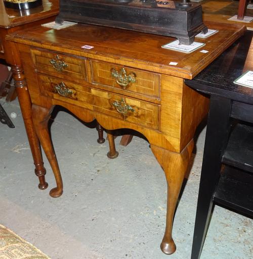 A Queen Anne style mahogany and walnut side table with two short and one long drawer on tapering pad feet, 67cm wide x 75cm high.   H6