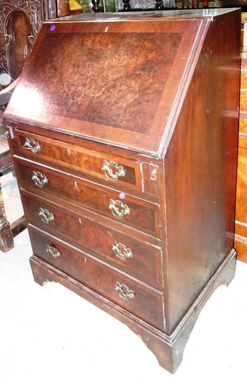 A 20th century mahogany bureau with fitted interior over four long drawers on bracket feet, 59cm wide x 95cm high.  BAY 1