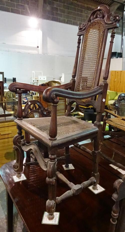 A set of six 17th century style oak high back dining chairs on turned stretchers to include two carvers, (6).  H7