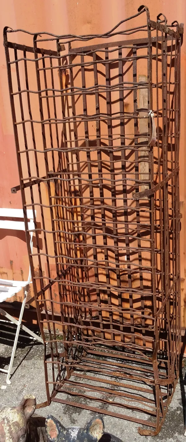 An early 20th century wrought iron fifteen tier wine rack, 55cm wide x 167cm high.   OUT