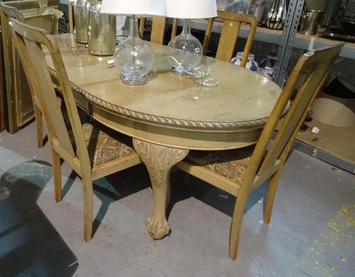 A 20th century bleached mahogany extending dining table on ball and claw feet, 165cm wide x 70cm high and a set of six mahogany dining chairs, (7).