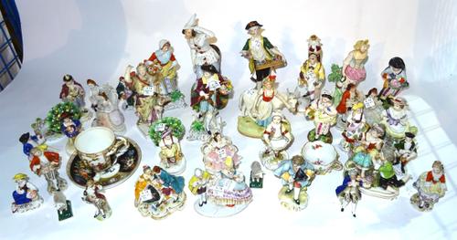 A large quantity of mainly early 20th century continental porcelain figures.  S2M