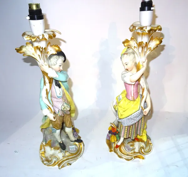 A pair of 20th century figural porcelain table lamps formed as a gallant and his companion, 46cm high, (a.f) (2).  F4