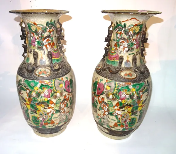 A pair of Chinese ceramic vases decorated with warriors, 46cm high, (2).  S3B