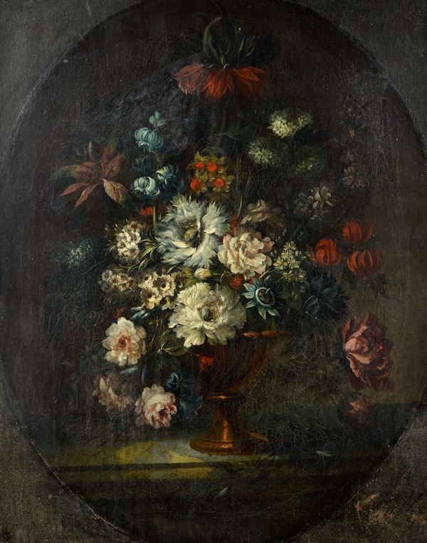 Dutch School (18th century), Still life of flowers in an urn on a marble ledge, oil on canvas, in a feigned oval, 89cm x 71cm. Illustrated.
