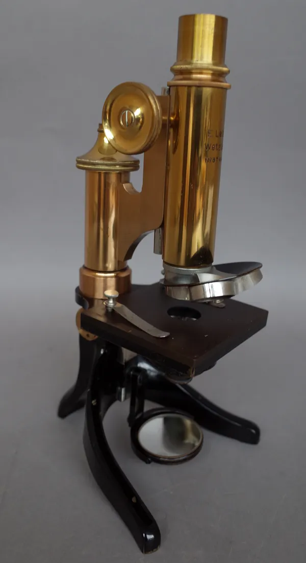 A lacquered brass monocular microscope by E. Leitz Wetzlar, with three cased objectives and accessories, in a fitted mahogany case.