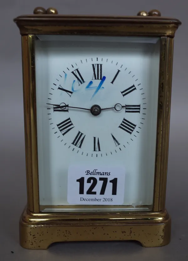 A French brass cased carriage clock, early 20th century, with visible platform escapement, white enamel dial and a two train movement with hammer stri