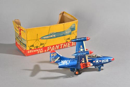 A Japanese Yonezawa Grumman F9F-5 Panther tin plate fighter jet with friction drive wheels, 30cm, partial box. Illustrated.
