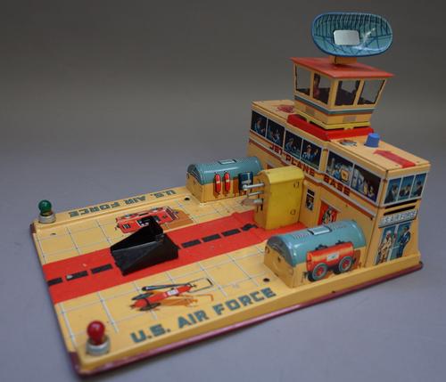 A Japanese Yonezawa tinplate 'Jet plane base', circa 1950, with automatic launching action, radar screen and buzzer, boxed.