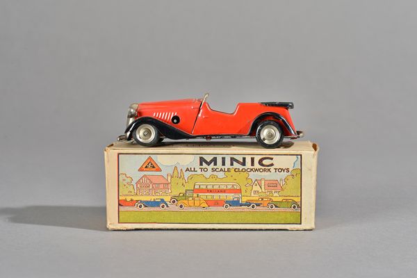 A Triang Minic No 12M post-war clockwork Vauxhall Learner's car, red with black wings, boxed. Illustrated.