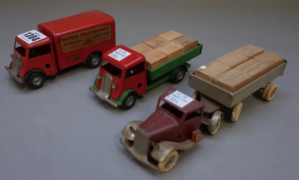 A Triang Minic clockwork transport lorry, red livery and two flat bed lorries, each containing wooden blocks, (3).