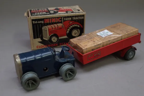 A Triang Minic farm tractor in blue, boxed and a red trailer containing six wooden blocks, (2).