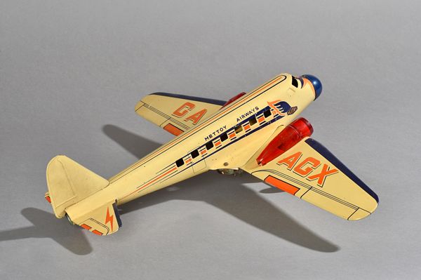 A British Mettoy Airways mechanical tinplate jet airliner with sparking jet engines, circa 1950, two tone cream blue, detailed 'GA-AGX' to wings, 55cm