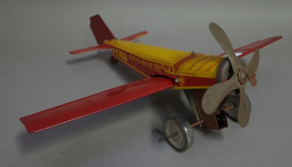 A French Joustra tin plate wind up aeroplane, circa. 1938, 'Air France' two tone red/yellow body, 32cm wide and three further 1930's tine plate aeropl
