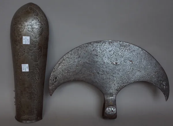 A Persian steel battle axe head of crescent form, engraved with Islamic script, 32.5cm wide and a Persian steel forearm armour plate with foliate engr