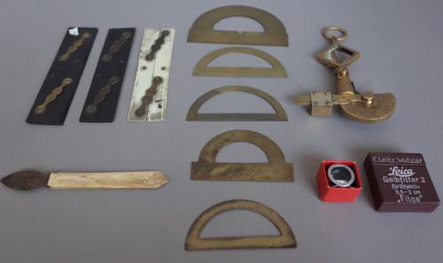 A Hyron's brass protractor, early 20th century, 10cm wide, four further early 20th century brass protractors, three  parallel rules, a bone handled st