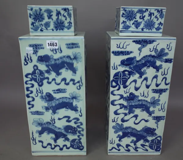 A pair of modern Chinese blue and white porcelain vases and covers each of square section, decorated with dragons chasing a flaming pearl, 47cm high,