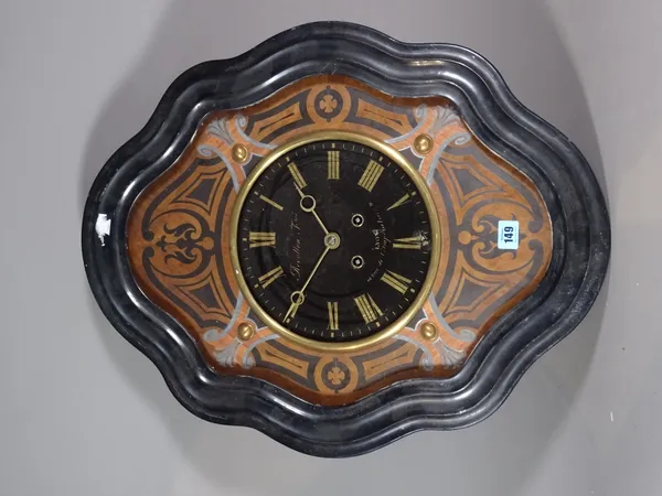 A Continental wall clock with shaped ebonised case and 8 day movement.   S2T