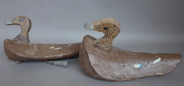 A pair of polychrome painted soft wood decoy ducks, early 20th century, each with lead weight to the underside, 33cm wide, (2).