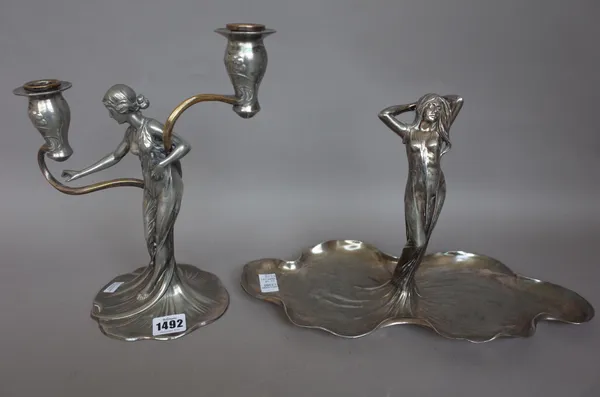 A WMF pewter Art Nouveau twin branch candlestick and a figural dish stamped maker's marks, circa 1900, 27.5cm high, (2).