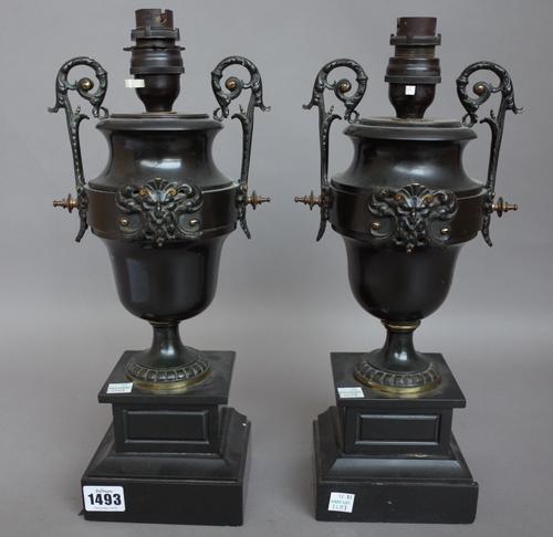 A pair of black slate, marble and ormolu mounted urns 19th century (converted to table lamps), each on stepped square base. (a.f.) 34cm high, (2).