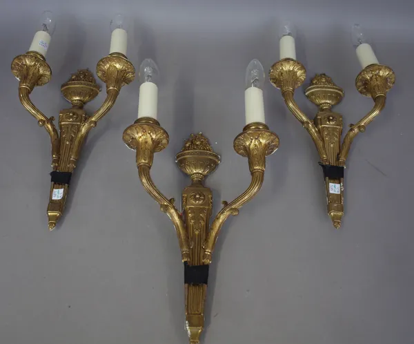 A set of three Louis XVI style gilt bronze twin branch wall lights with fruiting urn finial over a fluted tapering back plate (36cm), a pair of 18th c