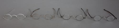 Four pairs of Georgian silver spectacles with oval lenses, early 19th century, maker's stamp on one for Thomas Phelps, no lenses, all four with turn p