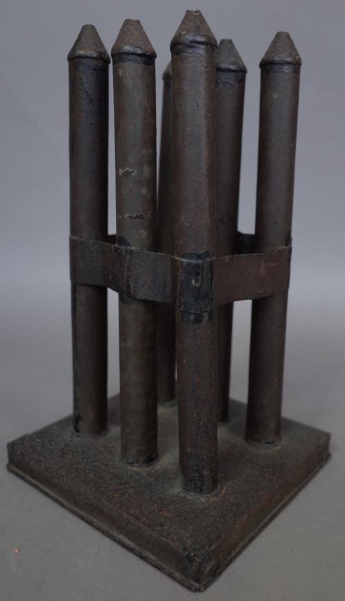 A rare six element tin candle mould, circa 1780, 23.5cm high, (this actual mould is illustrated in John Caspall' s book 'Making Fire & Light' page 47
