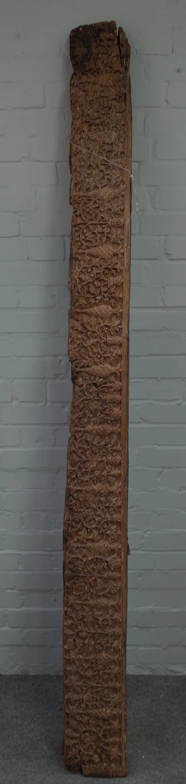 An Asian carved wooden beam, foliate design with signs of previous painted decoration, 228cm x 19cm x 10cm (a.f.).
