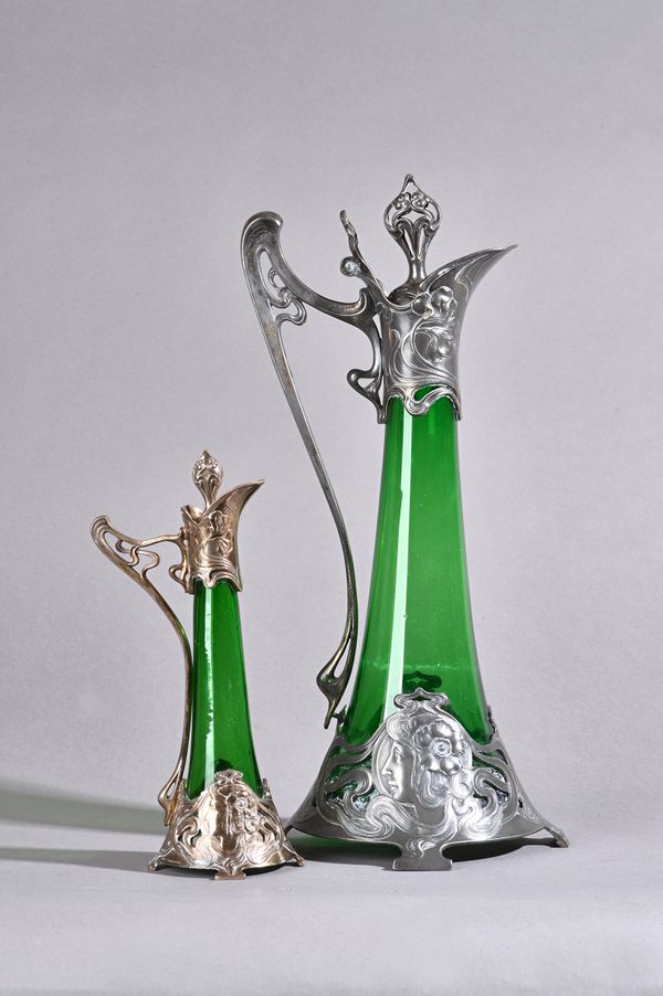 A WMF pewter figural Art Nouveau decanter with hinged stopper and green glass liner stamped maker's marks, circa 1900, 40cm high and another smaller m