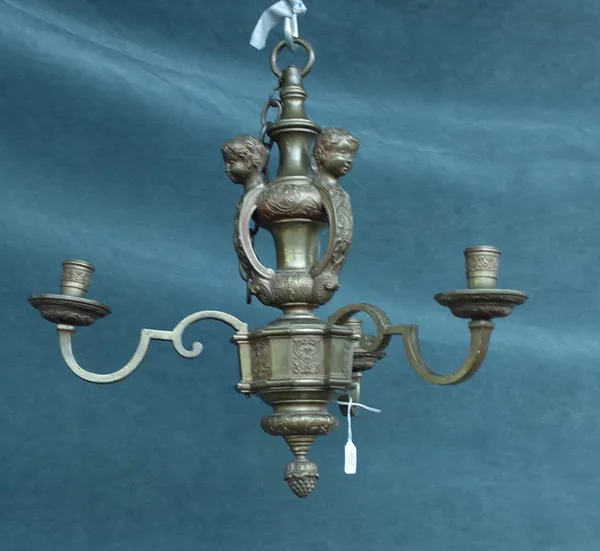 A Victorian bronze three branch chandelier, converted, cast with three cherub masks over a shaped foliate cast centre issuing three shaped branches, t